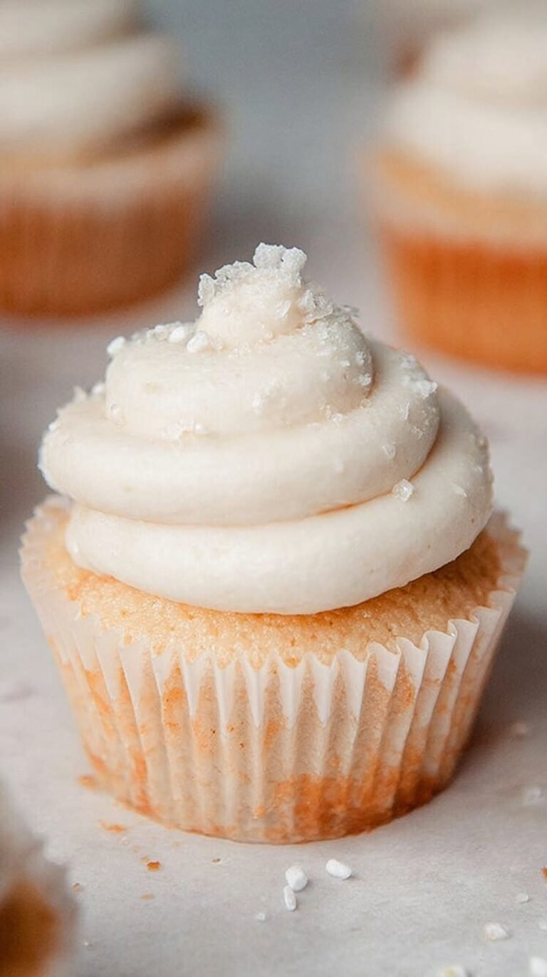Fluffy vanilla buttercream frosting swirled on top of a healthy cupcake