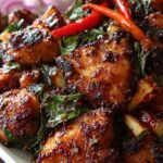 A glossy stir-fry of black pepper chicken with green peppers and onions in a dark sauce