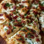 A golden-brown chicken bacon ranch pizza with melted mozzarella and fresh chives.