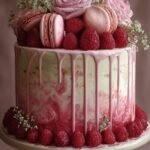 A beautiful multi-layered vanilla cake filled with bright red raspberry compote and topped with white mascarpone cream.