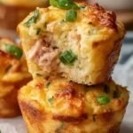 Golden brown tuna melt muffins in a muffin tin with green onions on top
