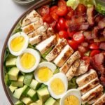 A colorful Protein Packed Cobb Salad arranged in neat rows with chicken, eggs, and avocado