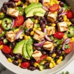 A colorful bowl of high protein cowboy caviar with black beans, edamame, and avocado