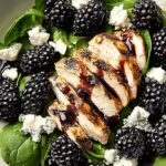 A fresh bowl of high protein blackberry salad with grilled chicken and goat cheese