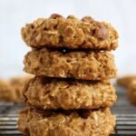 A tray of golden brown flourless banana cookies with oats and cinnamon.