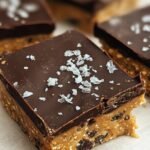 A close up of sliced chickpea protein bars with mini chocolate chips in a loaf pan.