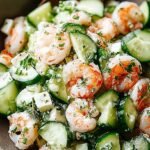 A bright bowl of cucumber shrimp salad with red onions and fresh dill