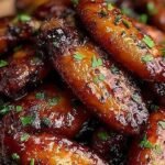 A platter of crispy glazed chicken wings with a sweet brown sugar and spicy cajun coating