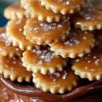 A tray of broken salted caramel cracker bites topped with chocolate and sea salt