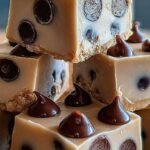 A tray of sliced peanut butter frozen yogurt bars topped with chocolate chips and peanuts