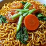 A bowl of creamy shrimp corn bisque topped with green onions and parsley.