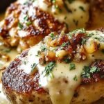 Grilled chicken breast topped with sautéed mushrooms, onions, and melted Monterey Jack cheese in a skillet.