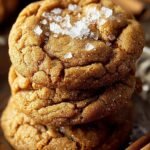 A stack of chewy brown butter pumpkin cookies rolled in cinnamon sugar on a cooling rack.