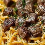 A bowl of beef garlic butter pasta with parsley and parmesan cheese