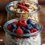 A jar of homemade instant oatmeal mix with a wooden spoon and fresh cinnamon sticks