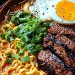 A bowl of creamy spicy Korean ramen topped with grilled beef, green onions, and a soft-boiled egg.