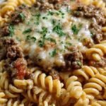 A bowl of creamy beef rotini pasta with garlic parmesan sauce and fresh parsley garnish