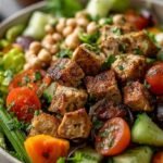 A vibrant Spring Cobb Salad arranged in rows with grilled chicken, eggs, asparagus, and avocado on a bed of romaine lettuce.