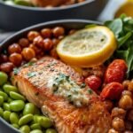 Two colorful salmon bowls with rice, spinach, cucumber, and avocado slices.