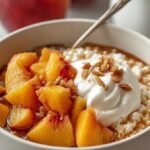 A fresh peach cottage cheese bowl topped with sliced peaches, honey, and walnuts.