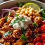 Four meal prep containers filled with chicken burrito bowls featuring rice, beans, and corn.