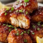 Golden brown air fried chicken bites coated in a sticky barbecue sauce glaze