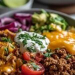 A colorful meal prep bowl with ground turkey, black beans, corn, and fresh salsa