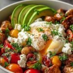 A fresh savory cottage cheese bowl topped with cucumbers, tomatoes, and olives