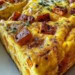 A golden brown protein-packed sweet potato egg casserole with spinach and turkey in a glass baking dish