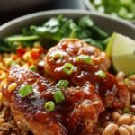 Four glass meal prep containers filled with BBQ chicken, roasted sweet potatoes, broccoli, and black beans