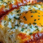 Two golden, puffed baked cottage cheese eggs in white ramekins topped with fresh chives.