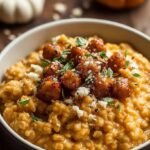 A bowl of creamy savory cottage cheese oatmeal topped with orange pumpkin and crunchy pepitas.