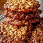 A tray of golden brown apple pie oatmeal cookies on parchment paper