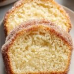 A sliced loaf of cinnamon sugar donut bread showing a soft interior and sparkling sugar crust