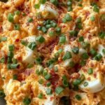 Golden brown pan-fried egg salad patties served on toasted sourdough bread with fresh chives.