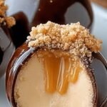 A platter of chocolate-covered peanut butter cheesecake balls with a creamy center.