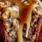 Golden brown caramel apple muffins with a caramel drizzle on a wire rack