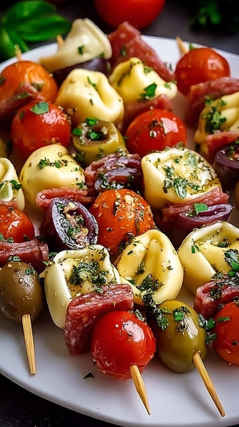 Platter of Italian antipasto skewers with tortellini, mozzarella, salami, and tomatoes