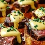 Grilled beef tenderloin medallions on toasted baguette slices topped with yellow Béarnaise sauce and fresh tarragon